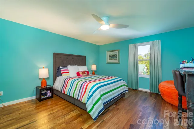 a bedroom with a bed and a table in it