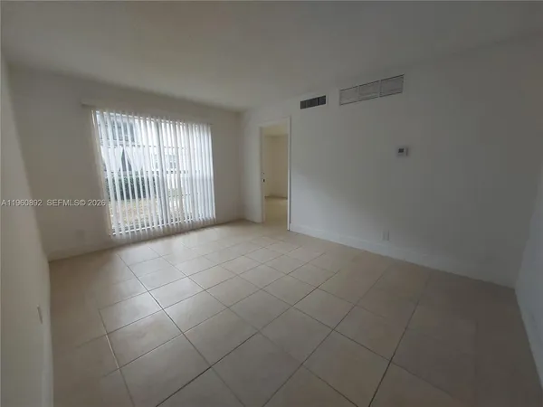 a view of an empty room with a window