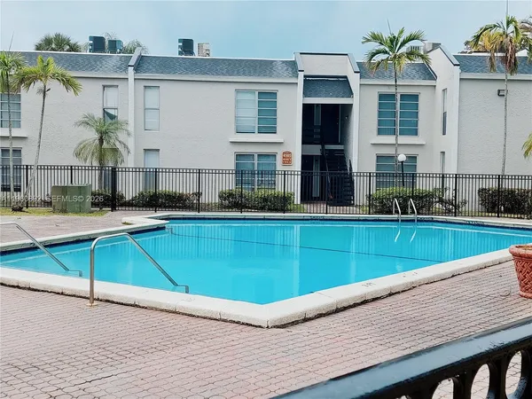 a view of swimming pool with outdoor seating and yard