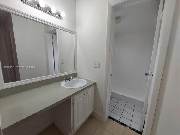 a bathroom with a sink a mirror and a shower