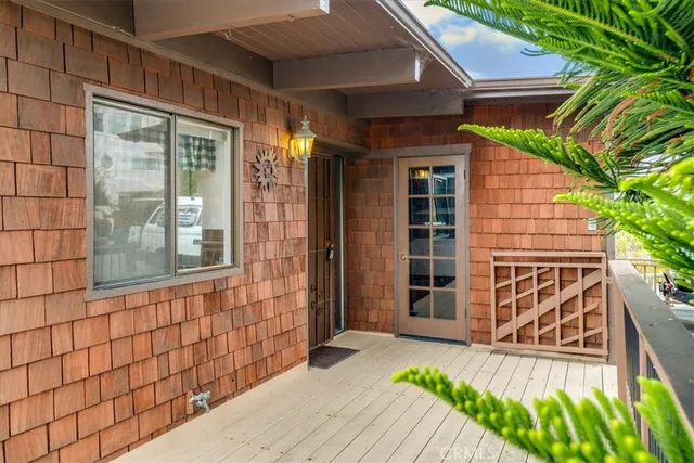 a view of a swimming pool with chairs in patio