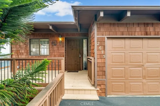 a view of a patio with a table chairs and backyard