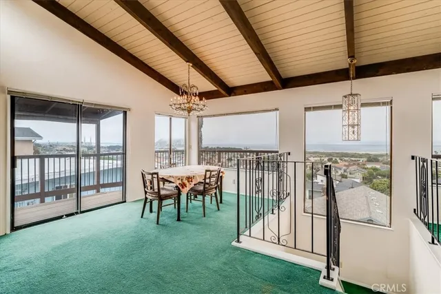 a living room with fireplace furniture and a floor to ceiling window
