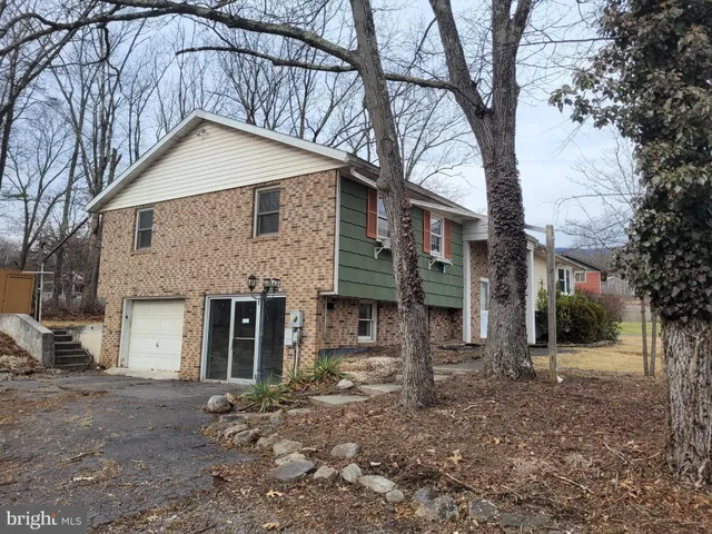 a house that has a tree in front of the house
