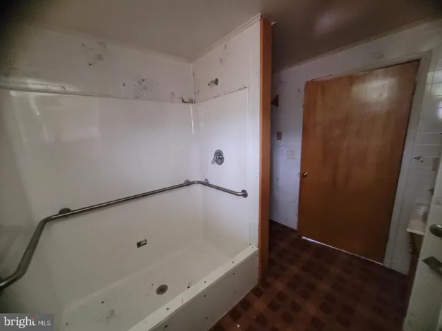 a bathroom with a tub and shower