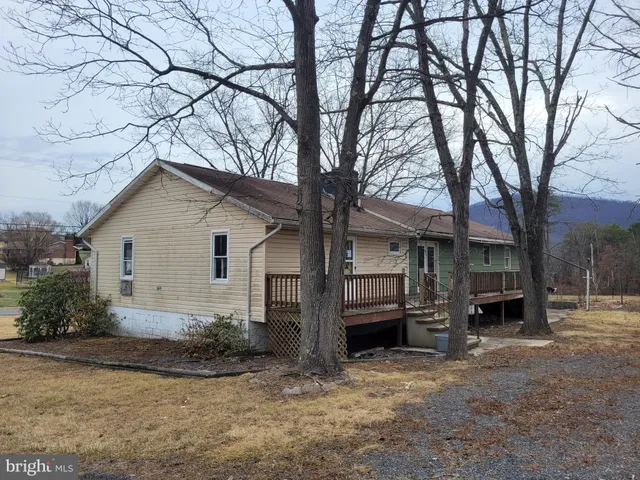 a view of house covered with snow in front of house