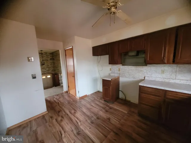 a kitchen with granite countertop a stove a sink and a microwave