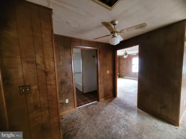 wooden floor in an empty room and a bathroom