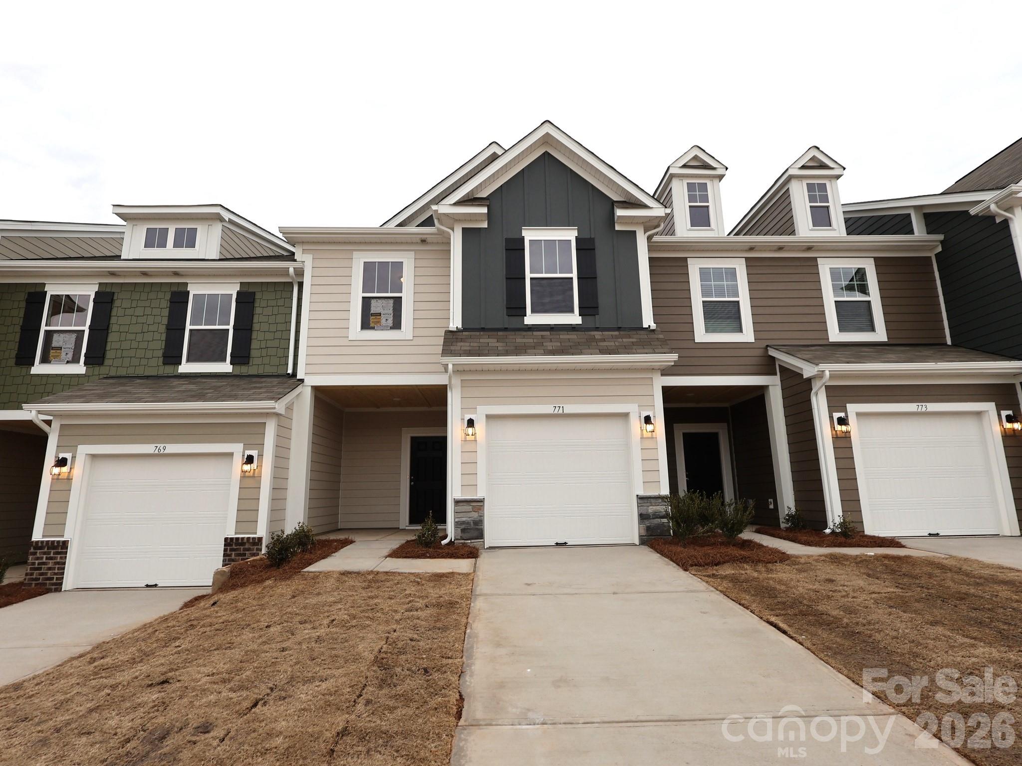 771 Kitfox Drive Northwest Concord, NC 28027 - Photo 1 of 4 a front view of a house with a yard and garage