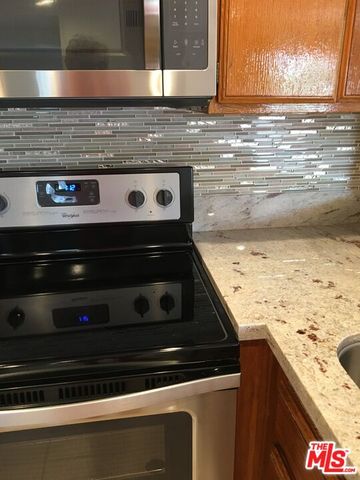 a stove top oven sitting inside of a kitchen