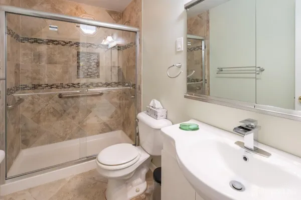 a bathroom with a sink toilet and shower