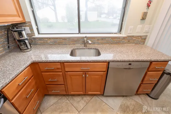 a kitchen with granite countertop a sink and a window