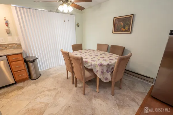 a view of a dining room with furniture and a chandelier