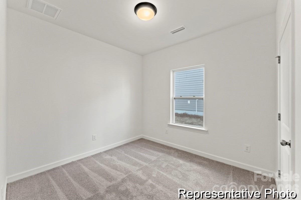 137 Soft Breeze Bend, Unit 283B Locust, NC 28097 - Photo 11 of 21 an empty room with windows