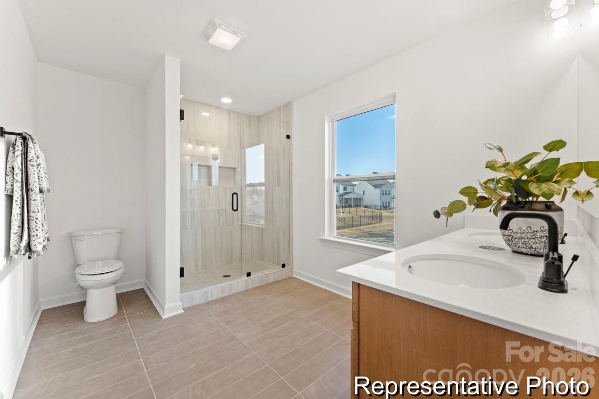 137 Soft Breeze Bend, Unit 283B Locust, NC 28097 - Photo 15 of 21 a bathroom with a sink toilet and shower