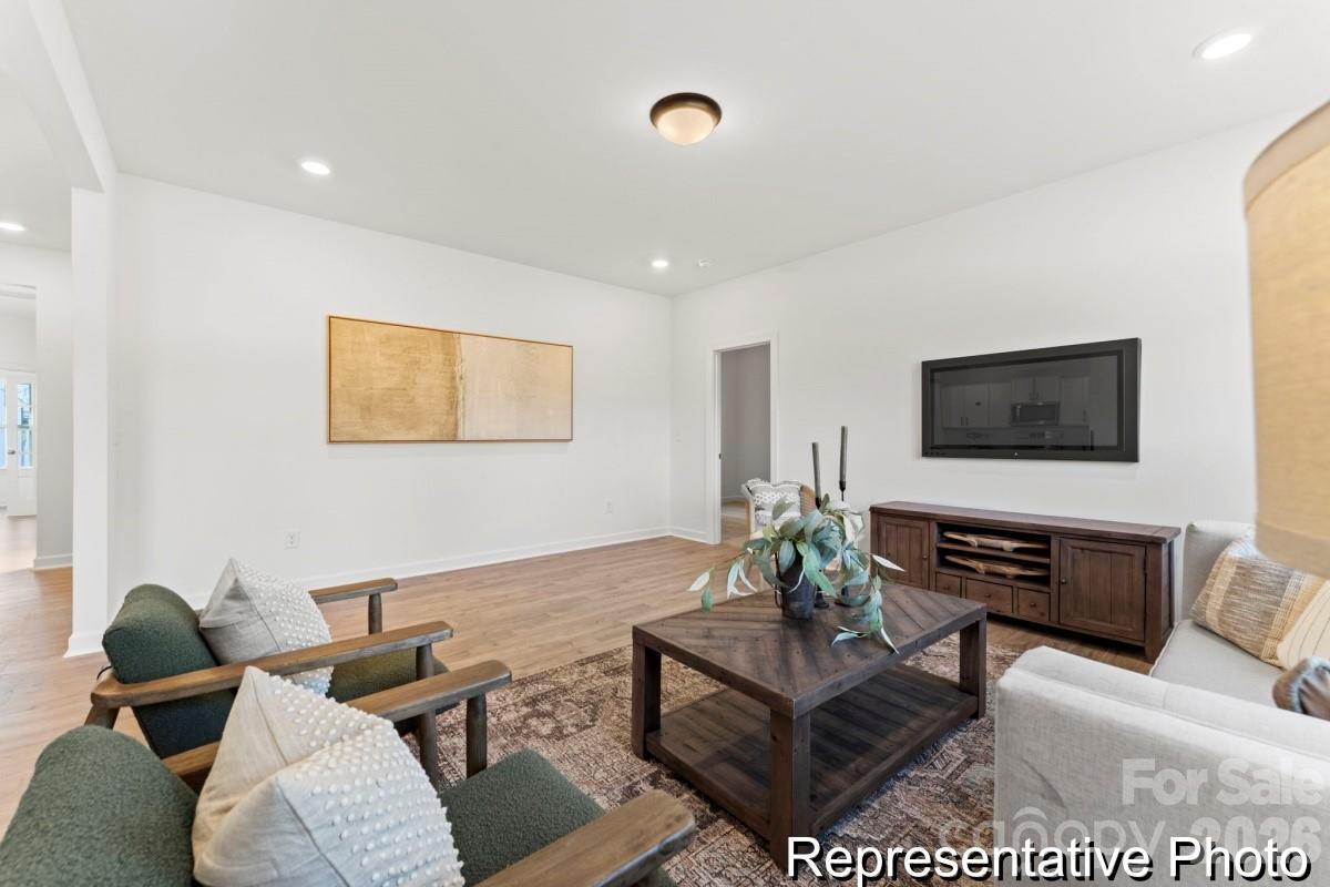 137 Soft Breeze Bend, Unit 283B Locust, NC 28097 - Photo 8 of 21 a living room with furniture and a flat screen tv