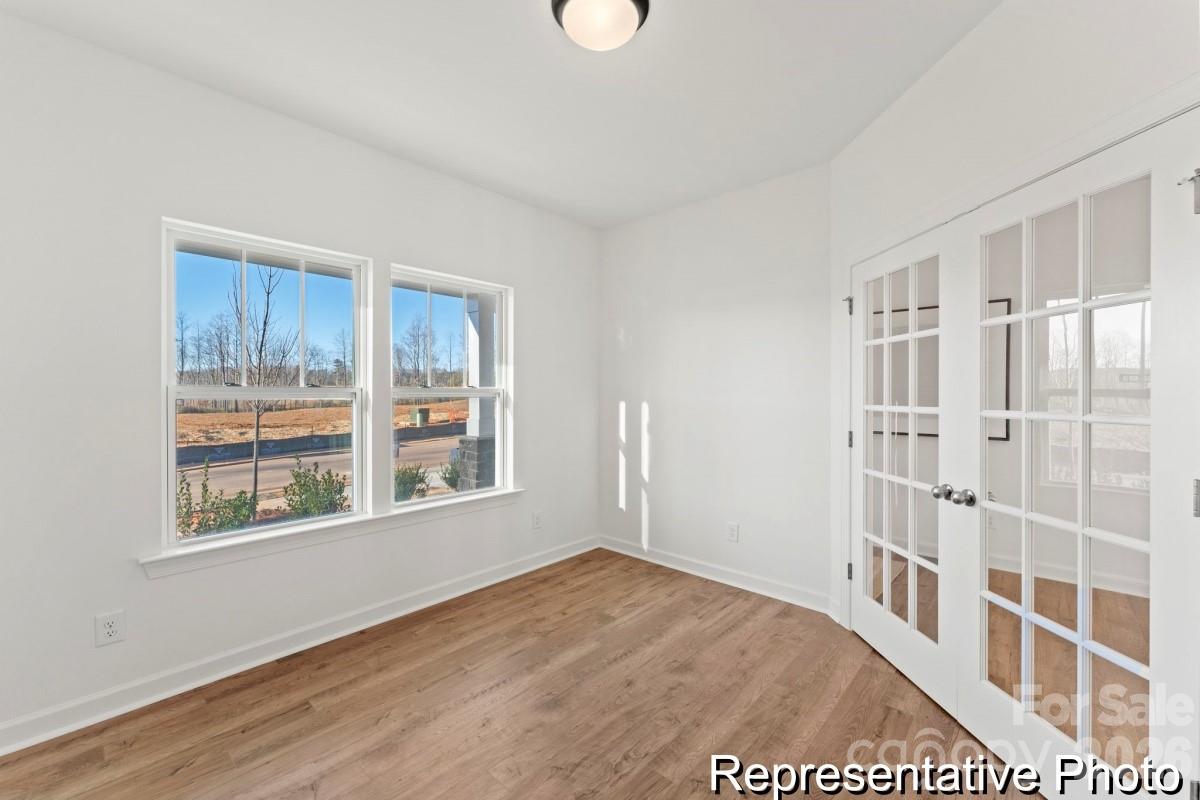 137 Soft Breeze Bend, Unit 283B Locust, NC 28097 - Photo 10 of 21 a view of a livingroom with wooden floor and windows