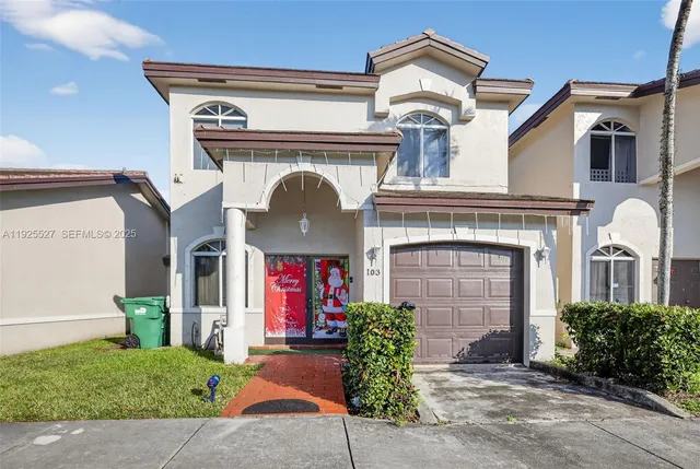 a front view of a house with a garden