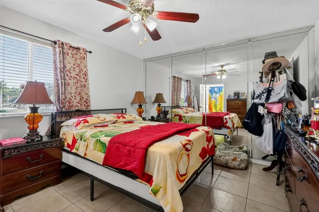 a bedroom with bed and wooden floor