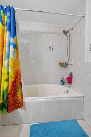 a bathroom with a bathtub and a shower