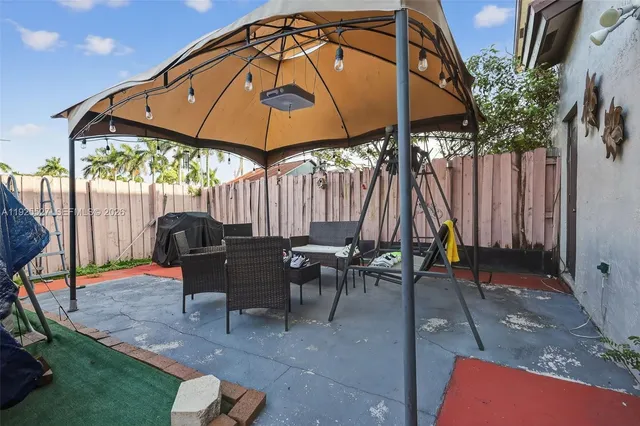 a patio with tables and chairs