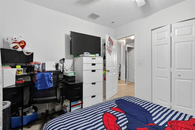 a bedroom with furniture and a flat screen tv