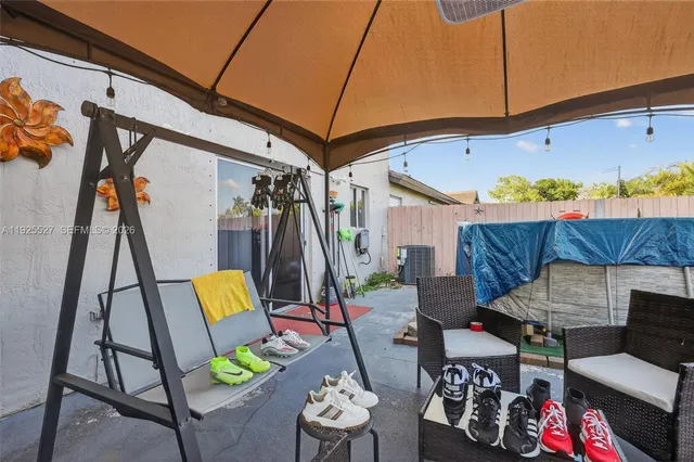 a view of a chairs and table in patio
