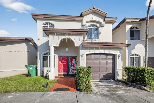a front view of a house with a garden