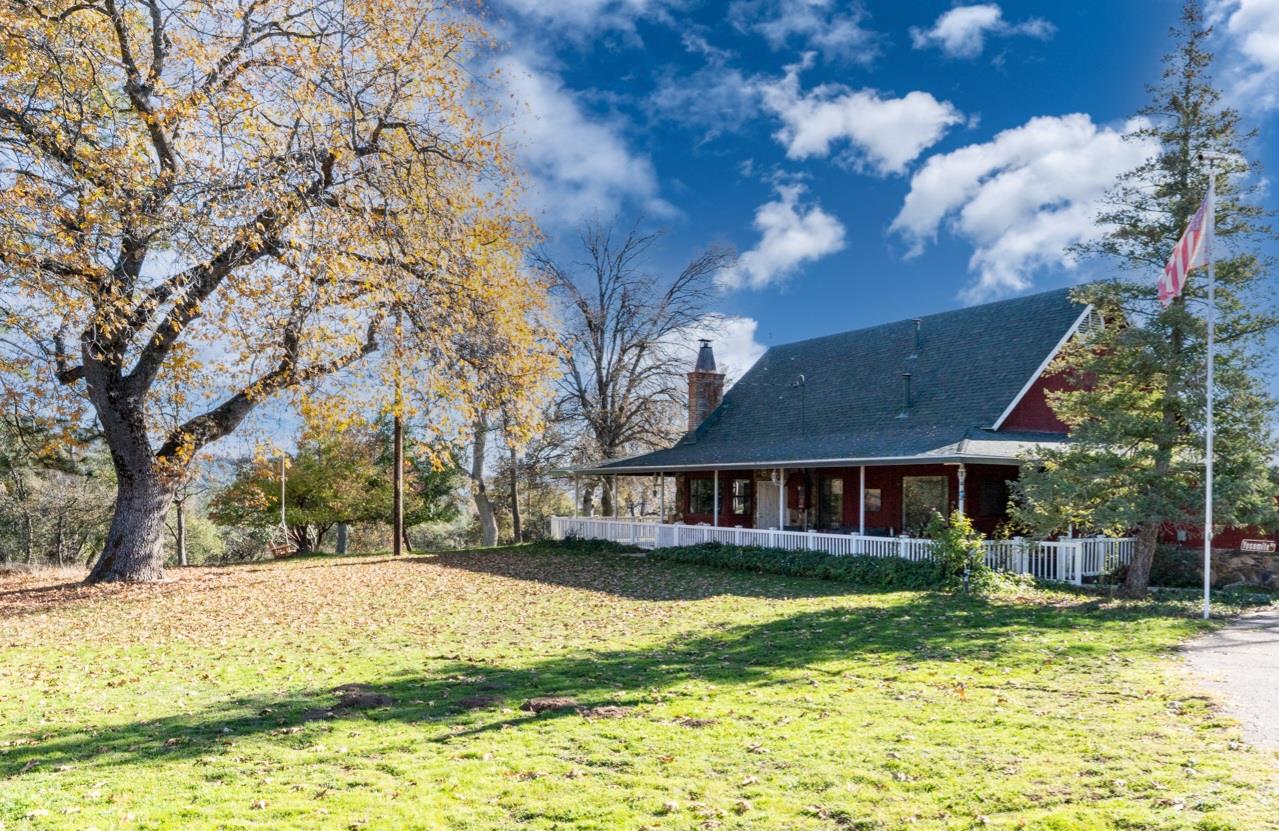 a view of a house with a yard covered with snow