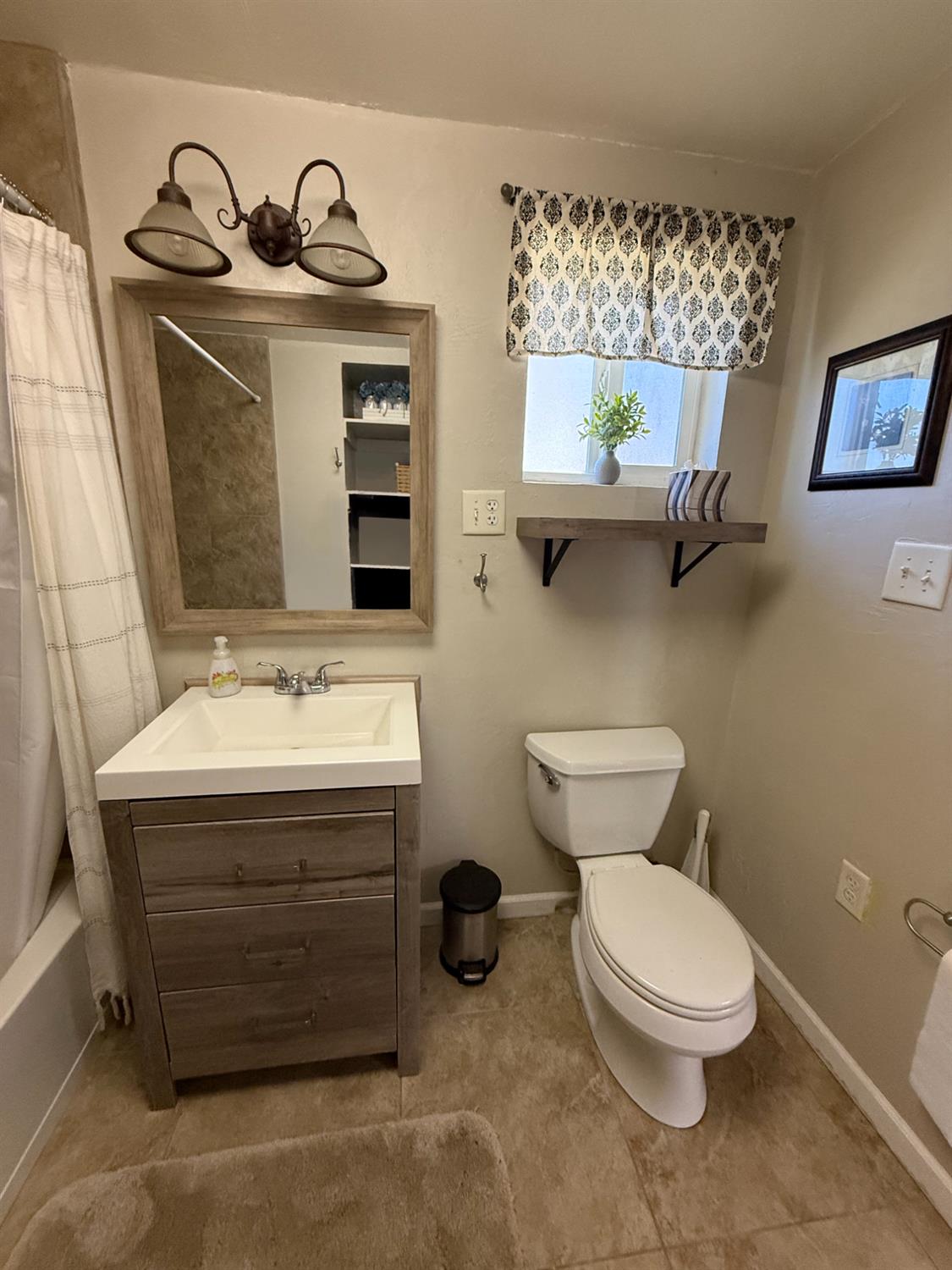 47515 Bissett Station Road Oakhurst, CA 93644 - Photo 16 of 59 a bathroom with a toilet a sink and mirror