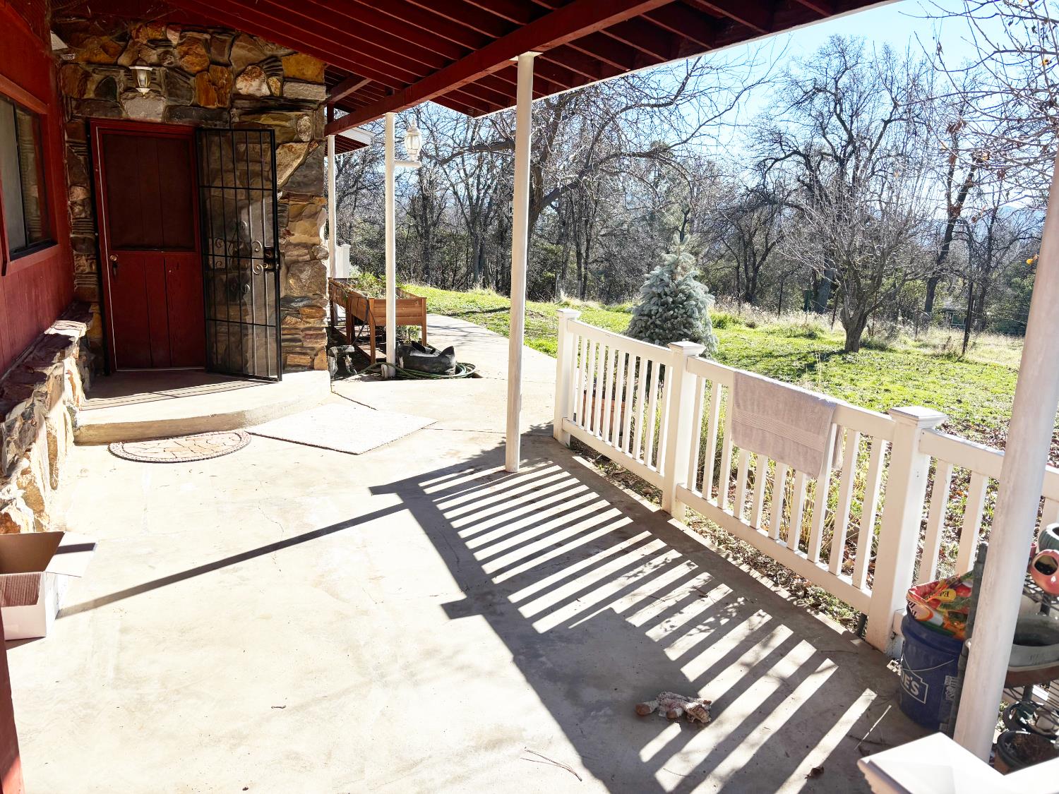 47515 Bissett Station Road Oakhurst, CA 93644 - Photo 29 of 59 a view of a patio with a table chairs and a barbeque