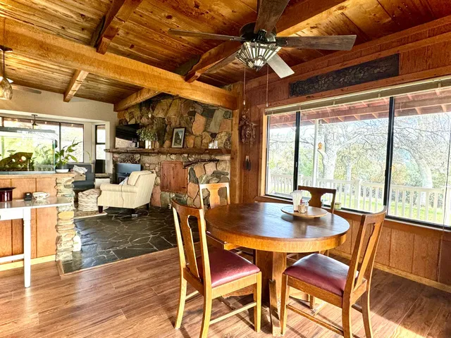 a dining room with furniture a chandelier and wooden floor