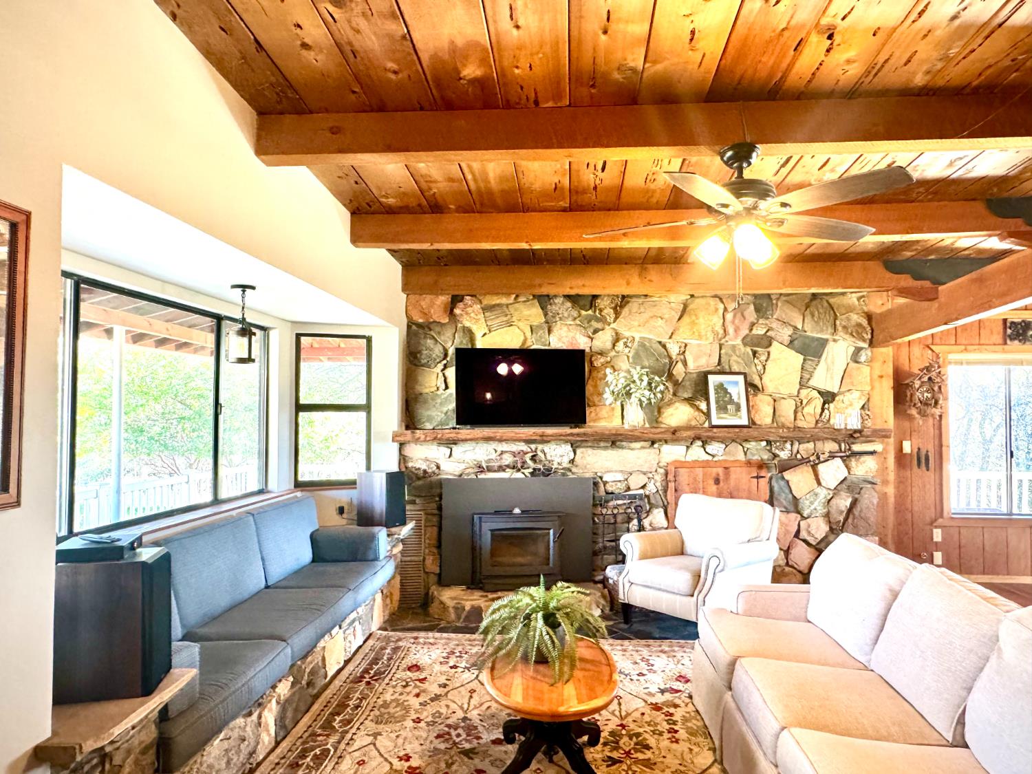 47515 Bissett Station Road Oakhurst, CA 93644 - Photo 32 of 59 a living room with furniture a flat screen tv and a fireplace