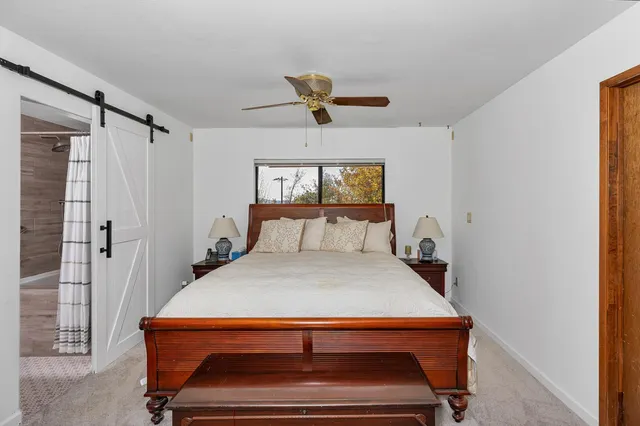 a bedroom with a bed and window