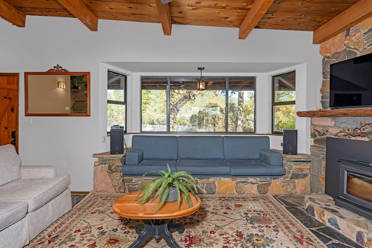 47515 Bissett Station Road Oakhurst, CA 93644 - Photo 36 of 59 a living room with furniture a flat screen tv and a fireplace