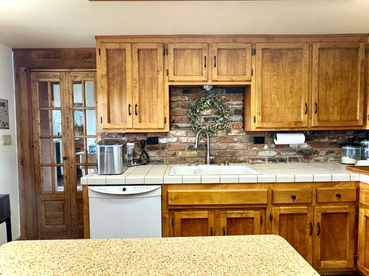 47515 Bissett Station Road Oakhurst, CA 93644 - Photo 43 of 59 a kitchen with stainless steel appliances kitchen island granite countertop a refrigerator and cabinets