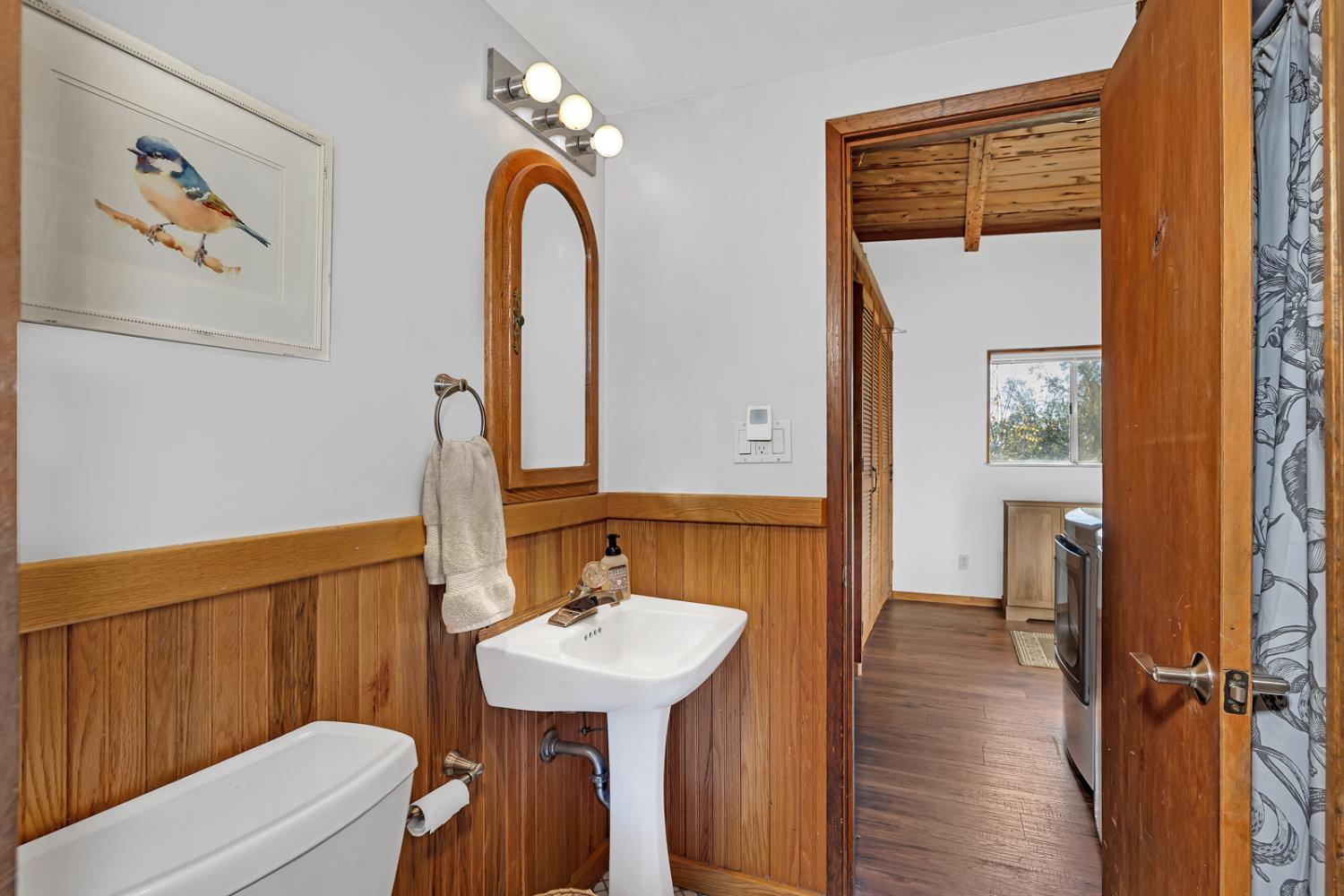 47515 Bissett Station Road Oakhurst, CA 93644 - Photo 56 of 59 a bathroom with a sink a mirror and a toilet