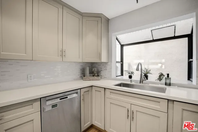 a view of a kitchen with an empty space wooden floor and a kitchen