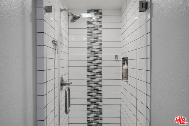 a bathroom with a bathtub and shower