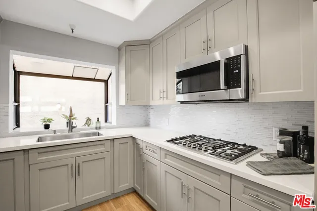 a kitchen with a sink and cabinets