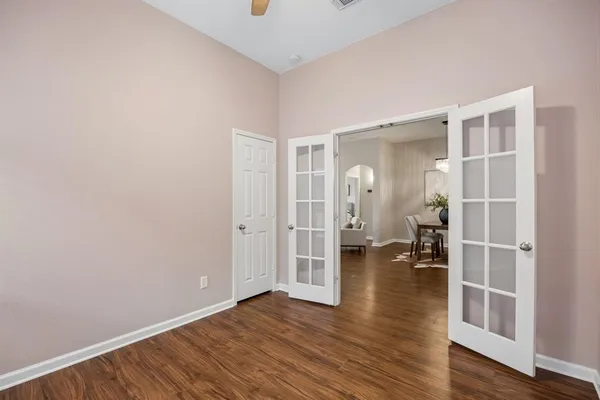 a view of empty room with wooden floor and windows