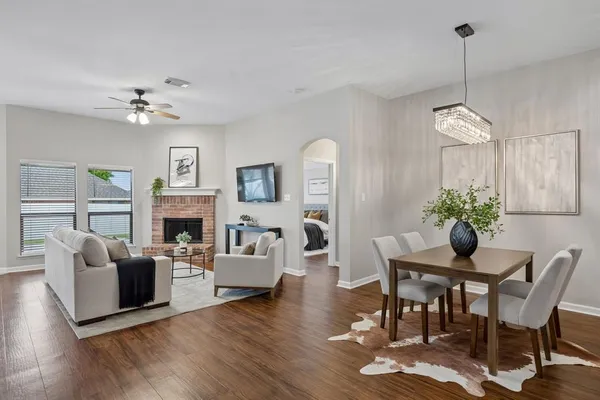 a living room with furniture a fireplace and a table