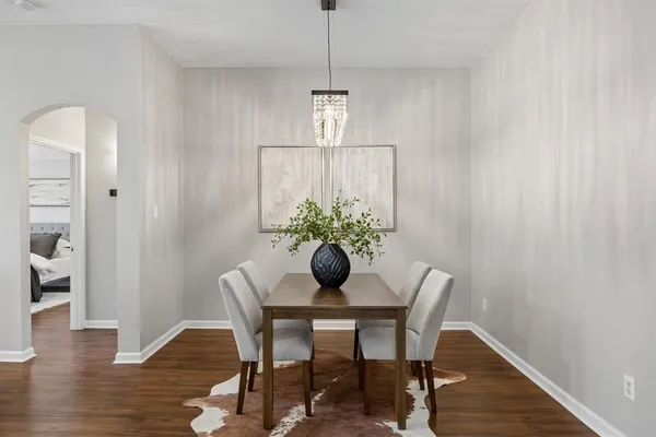 a dining room with furniture and wooden floor