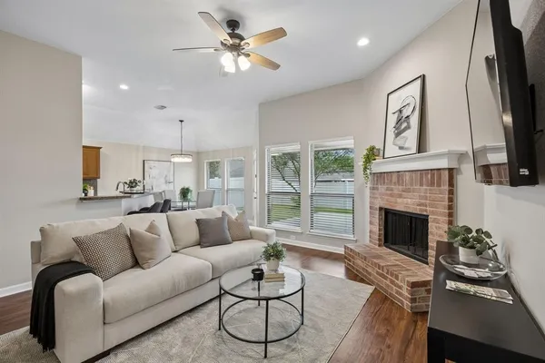 a living room with furniture fireplace and window
