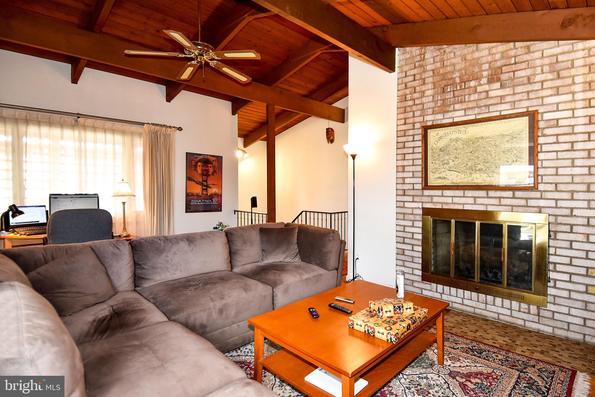 4121 Roberts Road Fairfax, VA 22032 - Photo 3 of 38 a living room with furniture a fireplace and a flat screen tv