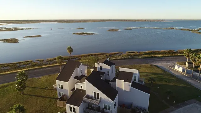 an aerial view of residential houses with outdoor space