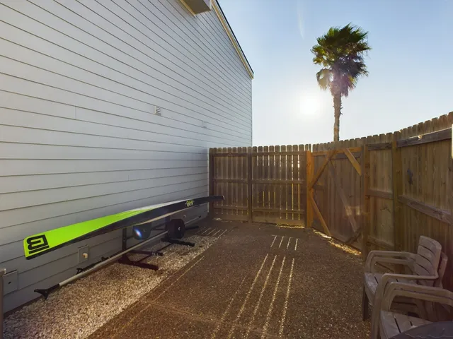 a view of a street with wooden fence