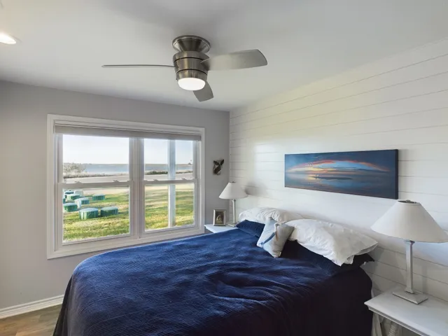 a bed sitting in a bedroom next to a window