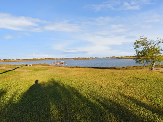 a view of a swimming pool with a yard