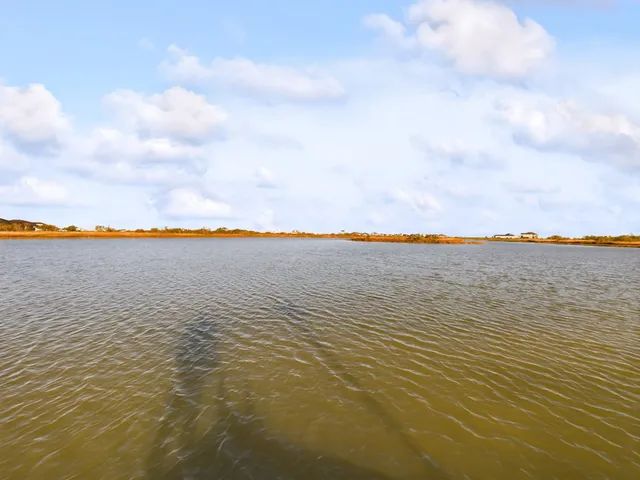 swimming pool with lake view and houses in the back